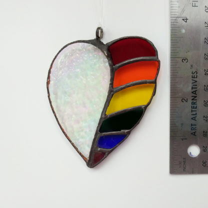stained glass rainbow heart with iridescent glass next to a ruler